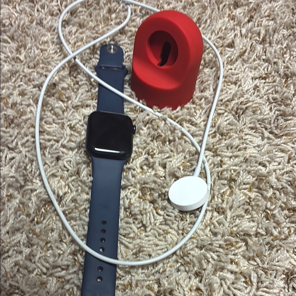 Apple Smartwatch with Blue Band and Red Stand